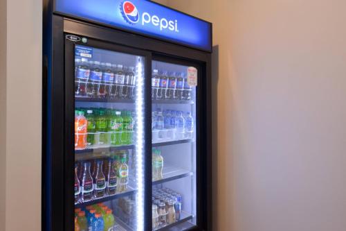 a refrigerator filled with lots of soda and sodas at Four Points By Sheraton Mount Prospect O’Hare in Mount Prospect