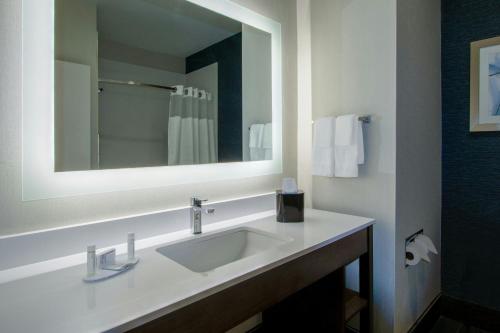 a bathroom with a sink and a mirror at Fairfield Inn & Suites Houston Katy in Katy