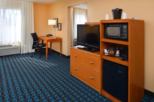 a hotel room with a television on a dresser at Fairfield Inn & Suites by Marriott Helena in Helena