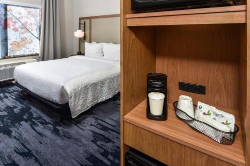 a hotel room with a bed and a tv at Fairfield Inn & Suites by Marriott Menifee in Menifee