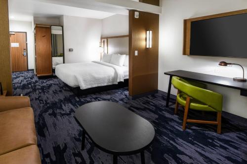 a hotel room with a bed and a desk at Fairfield Inn & Suites Ontario Rancho Cucamonga in Rancho Cucamonga