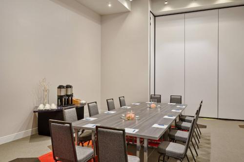a conference room with a long table and chairs at Four Points by Sheraton Dallas Fort Worth Airport North in Coppell