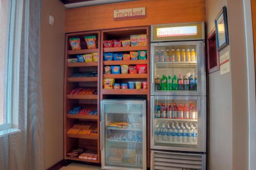 a refrigerator filled with lots of drinks in a room at Fairfield Inn & Suites by Marriott Mobile Daphne/Eastern Shore in Spanish Fort