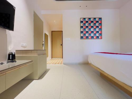 a hotel room with a bed and a bathroom at RIVERSCAPES by NOORJEHAN in Palakkad