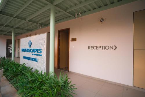 a building with a sign that reads reception at RIVERSCAPES by NOORJEHAN in Palakkad