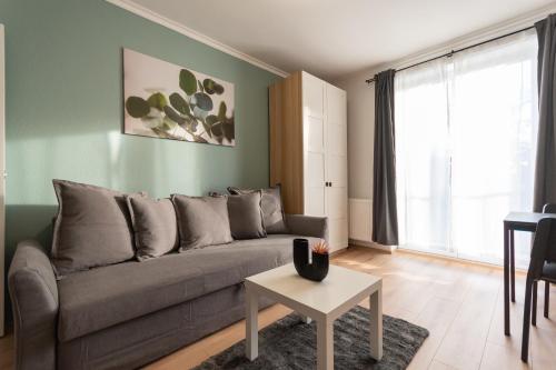 a living room with a couch and a table at R APARTMENTS BUDAPEST in Budapest