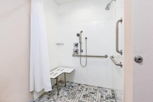 a bathroom with a shower with a bench in it at Fairfield Inn & Suites by Marriott Goshen in Goshen