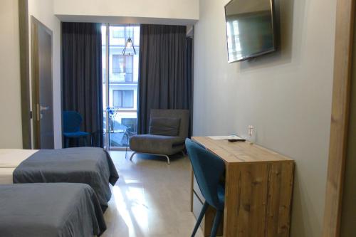 a hotel room with two beds and a television at Синя гора in Bukovel