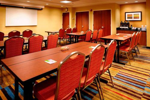 a conference room with wooden tables and chairs at Fairfield Inn by Marriott East Rutherford Meadowlands in East Rutherford