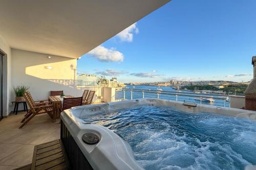 a hot tub on the balcony of a house at Jacuzzi Terrace Getaway with Valletta Views in Sliema