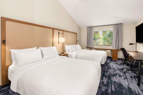 a hotel room with two beds and a desk at Fairfield Inn & Suites by Marriott Seattle Downtown/Seattle Center in Seattle