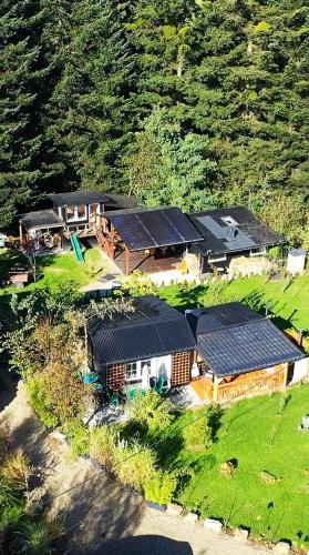 an aerial view of a house with solar panels on it at Zakątek u Poety Dąbrówka in Jasło