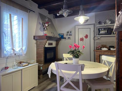 a dining room with a table and a fireplace at La dolce dimora in Chioggia