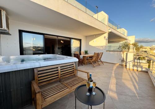 a hot tub on the balcony of a house at Jacuzzi Terrace Getaway with Valletta Views in Sliema