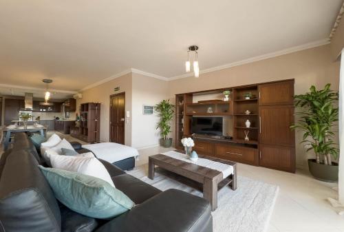 a living room with a couch and a table at Jacuzzi Terrace Getaway with Valletta Views in Sliema