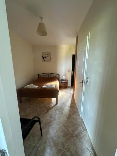 a bedroom with a bed and a chair and a door at Seapine Studios in Lassi