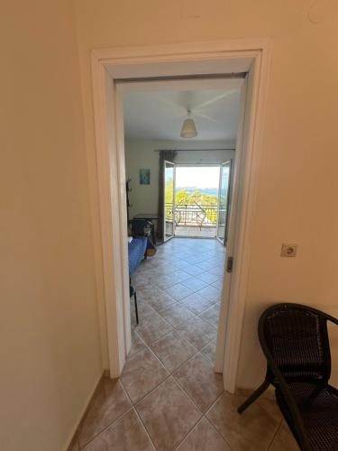 a hallway with a door leading to a balcony at Seapine Studios in Lassi