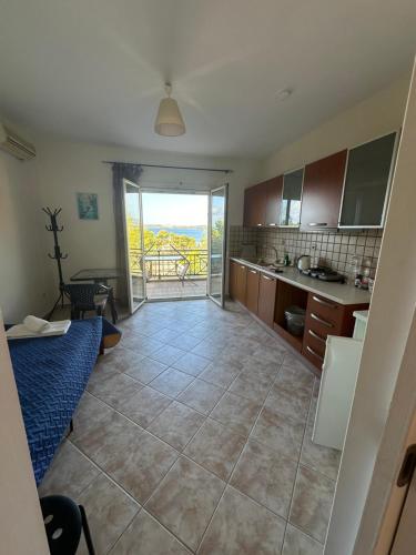 a kitchen with a large tiled floor with a view at Seapine Studios in Lassi