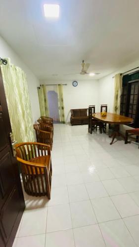 a room with chairs and a table and a table at Hasi Villa in Ahangama