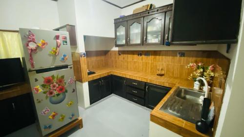 a kitchen with a refrigerator and a sink at Hasi Villa in Ahangama