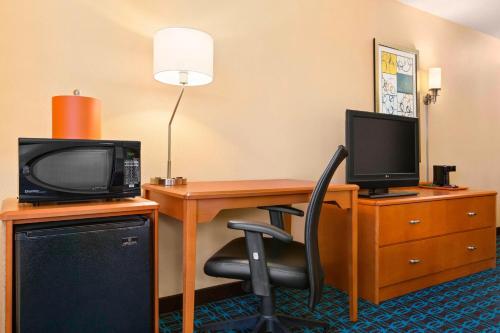 a hotel room with a desk with a tv and a computer at Fairfield Inn & Suites by Marriott Mankato in Mankato