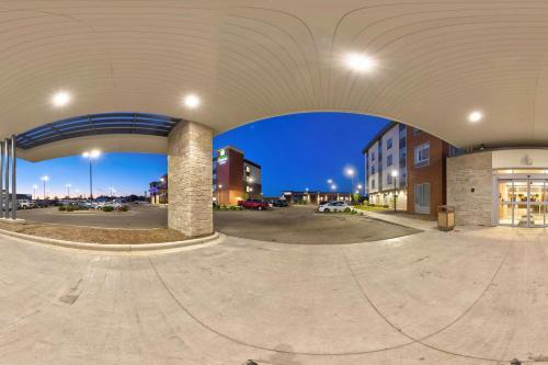 an empty parking lot with an arch in a building at Fairfield Inn & Suites by Marriott Milwaukee Brookfield in Brookfield