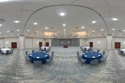 a large banquet hall with blue tables and chairs at Four Points by Sheraton Cleveland-Eastlake in Eastlake