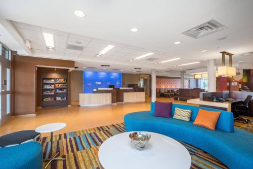 a living room with a blue couch and a table at Fairfield Inn & Suites by Marriott Bloomsburg in Bloomsburg