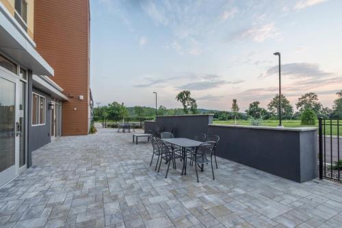 a patio with a table and chairs and a building at Fairfield Inn & Suites by Marriott Bloomsburg in Bloomsburg