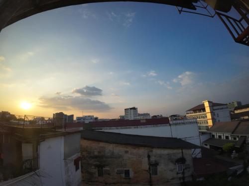 a view of a city skyline with the sun setting at Intouch Guest House in Vientiane