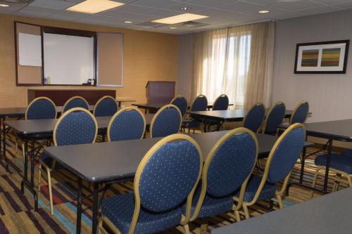a conference room with tables and chairs and a podium at Fairfield Inn by Marriott Morgantown in Morgantown