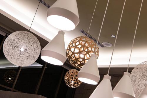 a bunch of lights hanging from a ceiling at Element Scottsdale at SkySong in Scottsdale