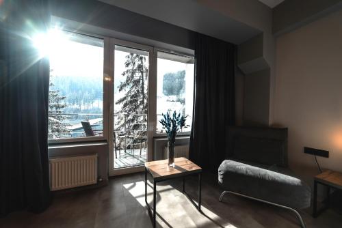 a living room with a large window and a couch at Синя гора in Bukovel