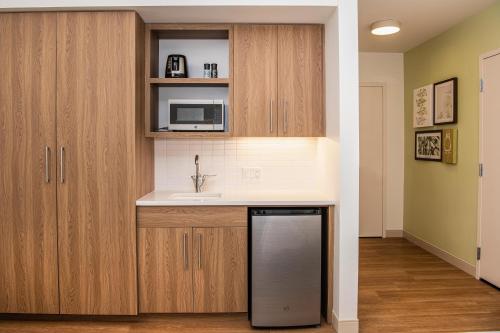 a kitchen with a sink and a microwave at Element Scottsdale at SkySong in Scottsdale