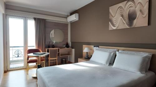 a hotel room with a bed and a mirror at Coral Hotel Athens in Athens