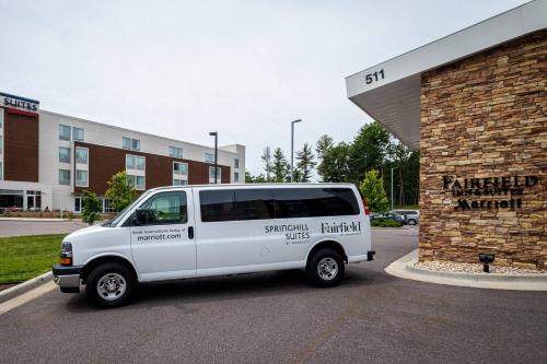 a white van parked in front of a building at Fairfield Inn & Suites by Marriott Wisconsin Dells in Wisconsin Dells