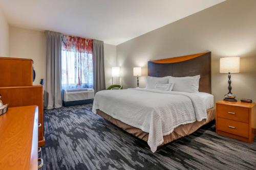 a hotel room with a large bed and a window at Fairfield Inn and Suites Holiday Tarpon Springs in Holiday