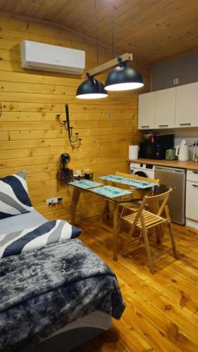 a kitchen and dining room with a table in a room at Zakątek u Poety Dąbrówka in Jasło