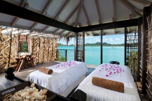 a bed room with two beds and a tent at Cocobay Resort Antigua - All Inclusive - Adults Only in Johnsons Point