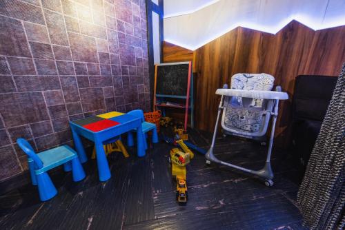 a toy room with a table and chairs and a chair at Синя гора in Bukovel