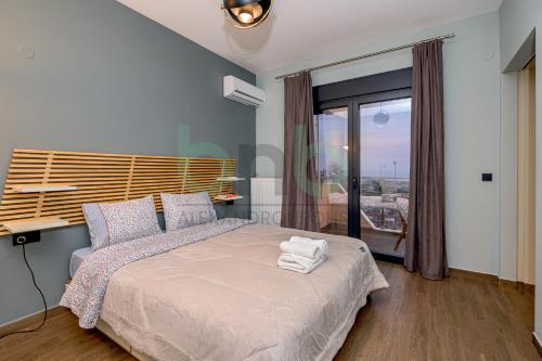 a bedroom with a bed with towels on it at Sea view luxury apartment in Alexandroupoli