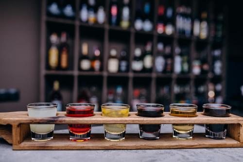 a wooden tray with different types of drinks on it at Синя гора in Bukovel
