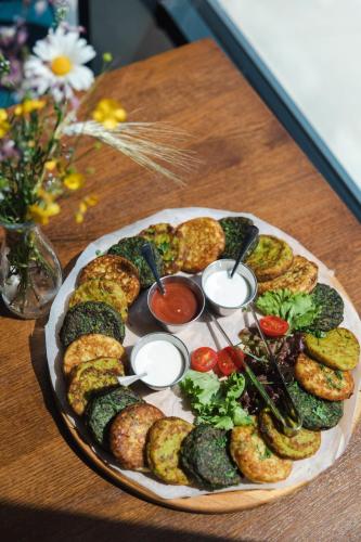 a plate of food on a table with appetizers at Синя гора in Bukovel