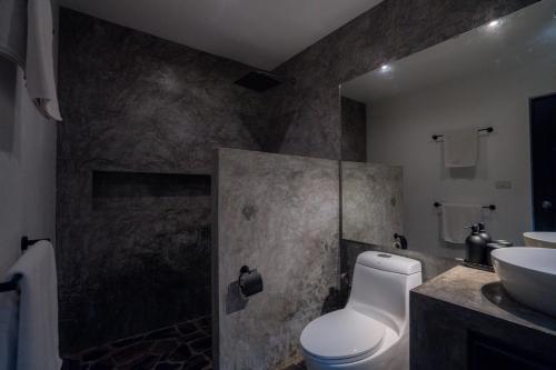 a bathroom with a toilet and a sink at Lunar Villas Koh Tao - Luxury Private Pool Villas in Koh Tao