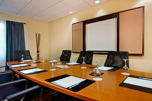 a conference room with a large wooden table and chairs at Fairfield Inn & Suites Fort Lauderdale Airport & Cruise Port in Dania Beach