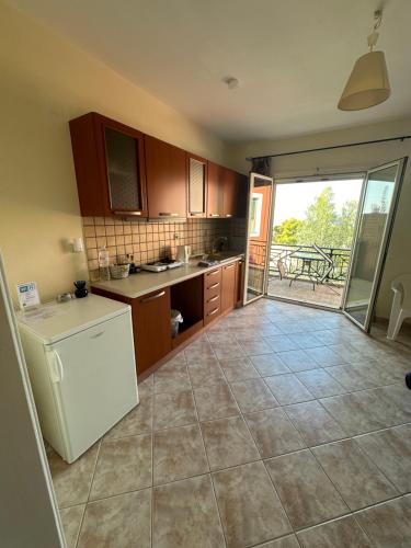 a kitchen with a white refrigerator and a table at Seapine Studios in Lassi
