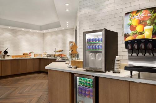a kitchen with a refrigerator with drinks on the counter at Fairfield Inn Erie Millcreek Mall in Erie
