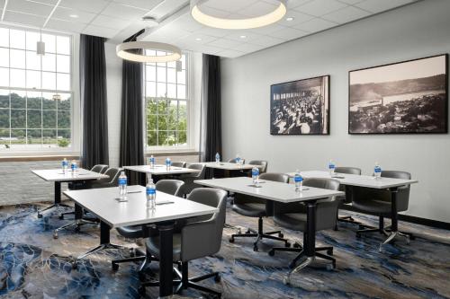 a conference room with tables and chairs and windows at Fairfield Inn & Suites Madison Historic Eagle Cotton Mill in Madison