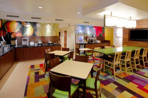 a restaurant with tables and chairs and a bar at Fairfield Inn and Suites by Marriott Tampa Brandon in Tampa