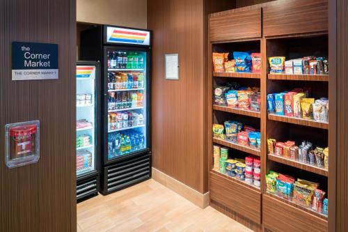 a store aisle with a refrigerator and shelves of food at Fairfield Inn & Suites by Marriott Houston Pasadena in Pasadena